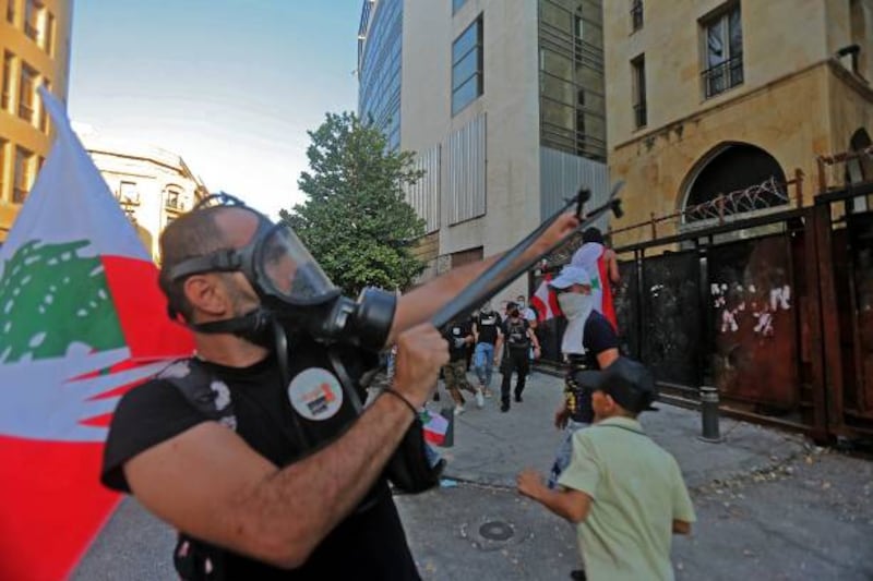 A man fires a slingshot as the security forces clash with demonstrators near Lebanon's parliament building in Downtown Beirut.