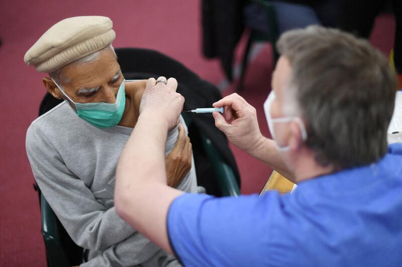 A health worker administers a dose of the AstraZeneca vaccine at a coronavirus vaccination centre at the Fazl Mosque in southwest London. AFP