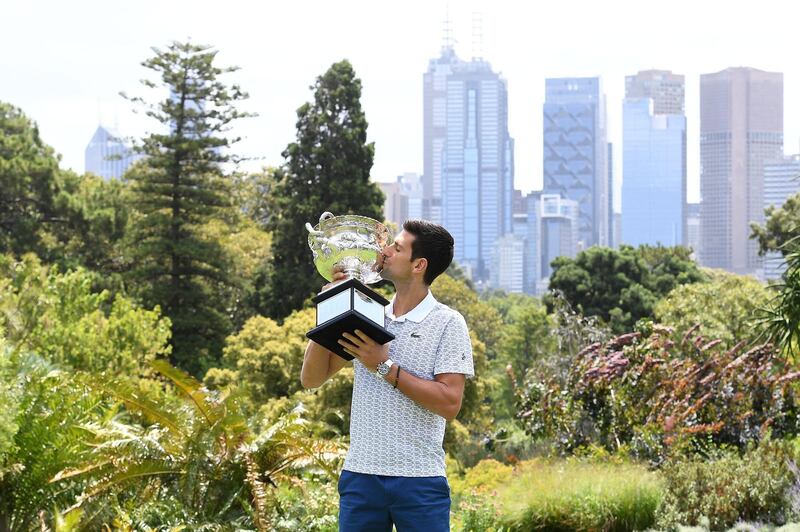Serbia's Novak Djokovic poses for photographs with the Norman Brookes Challenge Cup trophy at the Royal Botanical Gardens in Melbourne on February 3, 2020, a day after his victory against Austria's Dominic Thiem in the men's singles final of the Australian Open tennis tournament. IMAGE RESTRICTED TO EDITORIAL USE - STRICTLY NO COMMERCIAL USE
 / AFP / William WEST / IMAGE RESTRICTED TO EDITORIAL USE - STRICTLY NO COMMERCIAL USE
