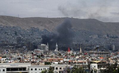 In this photo released by the Syrian official news agency SANA, smoke rises after shelling, apparently by Islamic State fighters, in Damascus, Syria, Wednesday, May 9, 2018. Militants fired three mortar shells on the center of Damascus Wednesday killing several persons and wounding 14, Syria's state news agency said. (SANA via AP)