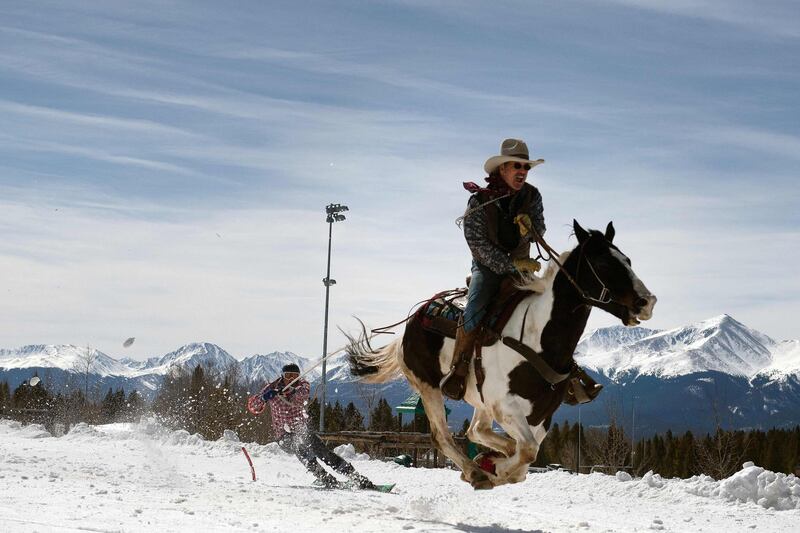 Rider Jeff Dahl races while skier and son Jason Dahl navigates a gate during the 73rd annual Leadville Skijoring weekend competition in Leadville, Colorado, US.  Skijoring sees a rider and skier win points by navigating jumps and slalom gates and spearing rings. AFP
