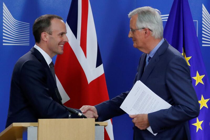 FILE PHOTO: Britain's Secretary of State for Exiting the European Union Dominic Raab and European Union's chief Brexit negotiator Michel Barnier shake hands during a joint news conference in Brussels, Belgium July 26, 2018. REUTERS/Yves Herman/File Photo
