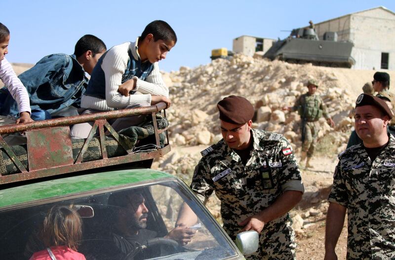 Lebanese security forces check identity and papers of Syrian refugees getting ready to cross into Syria from the eastern Lebanese border town of Arsal, on June 28, 2018. Stringer / AFP