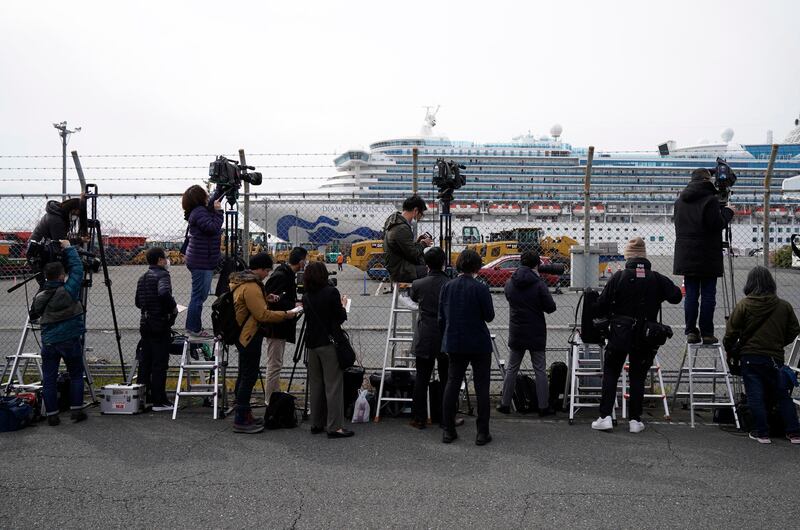 Members of the media report on the Diamond Princess cruise ship docked at the Daikoku Pier Cruise Terminal in Yokohama.  EPA