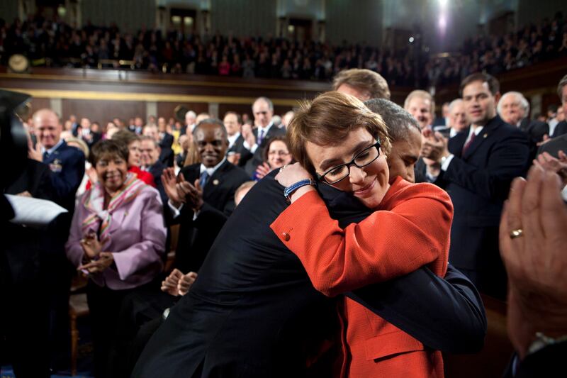 Mr Obama hugs Gabby Giffords as he arrives to deliver the State of the Union address in the House Chamber on January 24, 2012, at the US Capitol in Washington. Photo: The National Archives