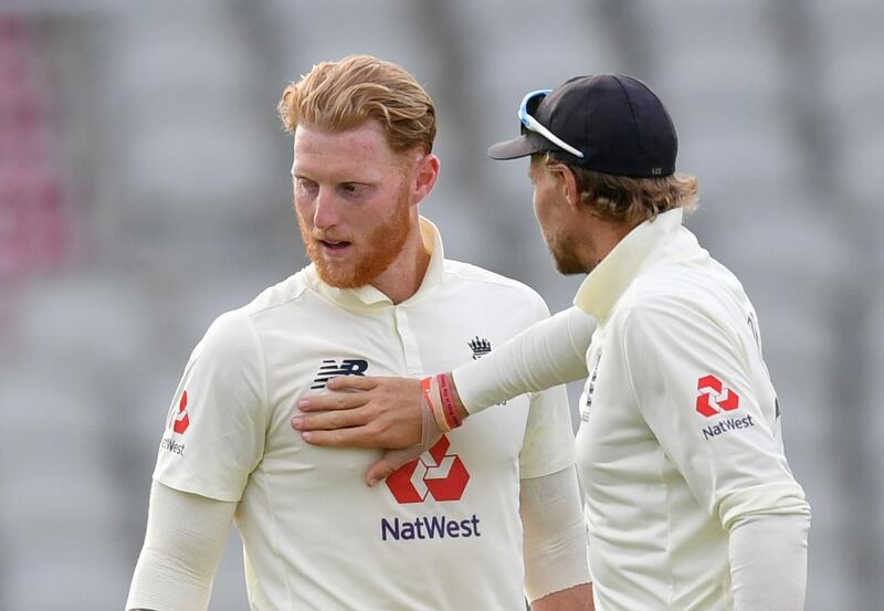FILE PHOTO: Cricket - First Test - England v Pakistan - Emirates Old Trafford, Manchester, Britain - August 7, 2020   England's Ben Stokes and Joe Root at the end of play, as play resumes behind closed doors following the outbreak of the coronavirus disease (COVID-19)   Dan Mullan/Pool via REUTERS - RC269I9K381J/File Photo