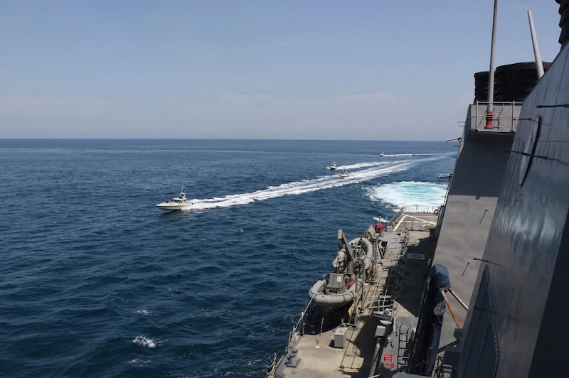 In this Wednesday, April 15, 2020, photo made available by the US Navy, Iranian Revolutionary Guard vessels sail close to US ships in the Arabian Gulf near Kuwait. All Photos supplied by US Navy