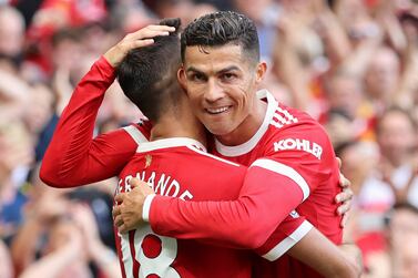 MANCHESTER, ENGLAND - SEPTEMBER 11: Bruno Fernandes of Manchester United celebrates with Cristiano Ronaldo after scoring their side's third goal during the Premier League match between Manchester United and Newcastle United at Old Trafford on September 11, 2021 in Manchester, England. (Photo by Clive Brunskill / Getty Images)