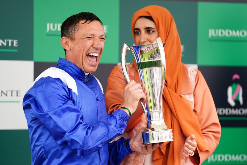 Frankie Dettori celebrates with owner Sheikha Hissa bint Hamdan Al Maktoum after being presented with the trophy following victory in the Juddmonte International Stakes. PA