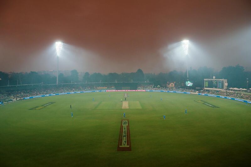 Smoke from bushfires in Canberra, Australia, hangs over the ground during the Big Bash League match between Sydney Thunder and Adelaide Strikers at Manuka Oval on Saturday, December 21. The match was abandoned due to the conditions. Getty