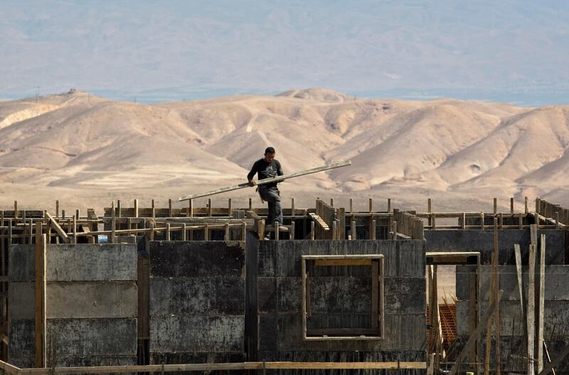 FILE - In this June 23, 2011 file photo, a worker is seen at a construction site in Maale Adumim. A leading rights group is accusing Israeli banks of contributing to the expansion of Jewish West Bank settlements by providing loans and mortgages for construction there. In the report, released Wednesday, Sept. 13, 2017, Human Rights Watch called on Israeli banks to extricate themselves from the settlements or face possible action from shareholders. (AP Photo/Sebastian Scheiner, File)