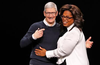 Tim Cook, CEO of Apple (L) and Oprah Winfrey hug during an Apple special event at the Steve Jobs Theater in Cupertino, California, U.S., March 25, 2019. REUTERS/Stephen Lam     TPX IMAGES OF THE DAY