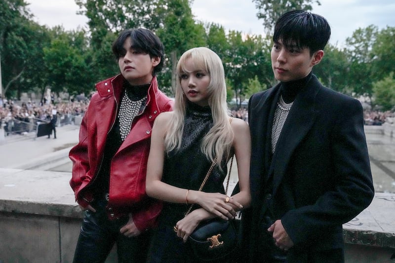 V, from left, Lisa, and Park Bo-gum pose for photographers before the Celine men's Spring Summer 2023 collection presented in Paris, France, Sunday, June 26, 2022.  (AP Photo / Francois Mori)