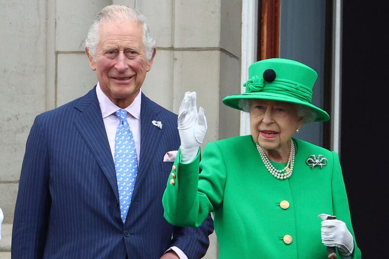 Britain's Queen Elizabeth II, pictured with Prince Charles, says poorer communities are less able to adapt to climate change. AP