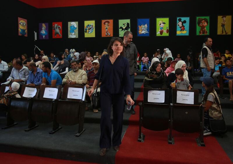 Johanna Colbec, co-founder of the Cinema Zaatari, and French film director and producer, Xavier Giannoli (behind), during the opening ceremony. AFP