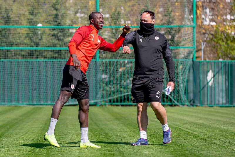 Slavia Prague manager Jindrich Trpisovsky, right, with Mohamed Tijani. EPA