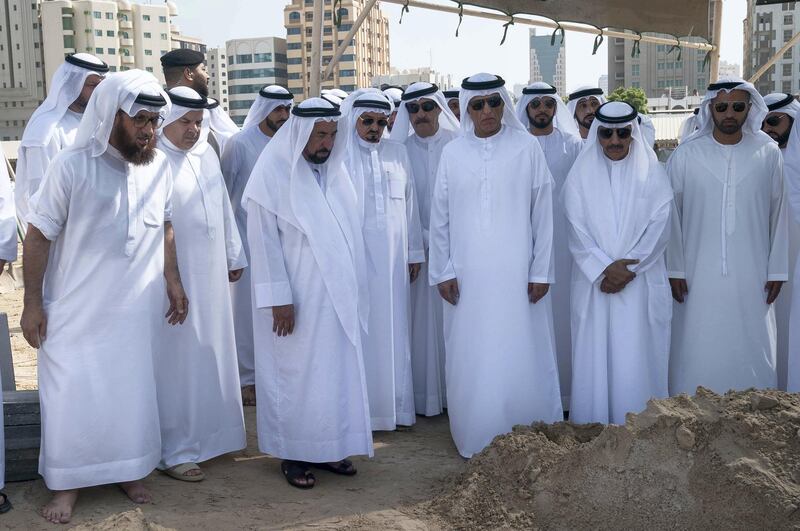 Sheikh Dr Sultan bin Muhammad, Ruler of Sharjah, Sheikh Humaid bin Rashid, Ruler of Ajman, Sheikh Saud bin Saqr, Ruler of Ras Al Khaimah and other sheikhs stand over the grave of Sheikh Khalid during his burial on Wednesday. Wam