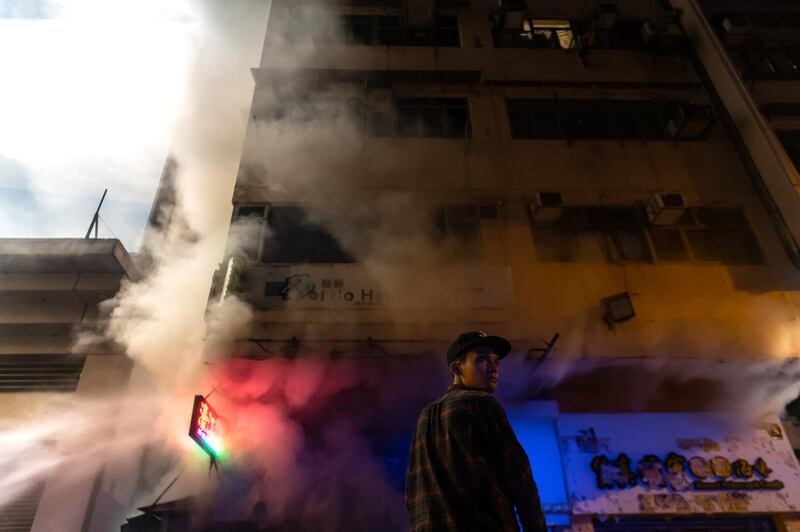 A man react as firefighters work to put out a blaze of a shop during a pro-democracy march at the Mongkok district in Hong Kong, China.  Getty