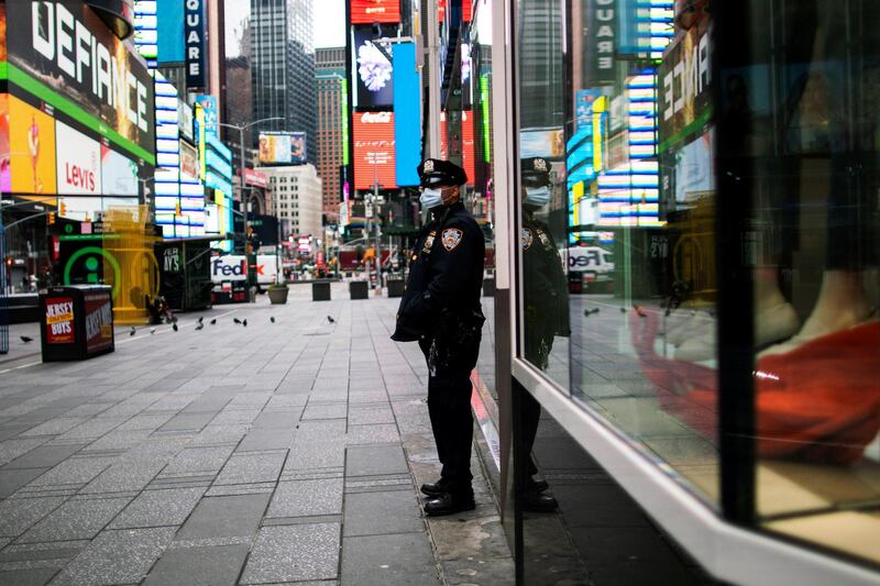 A New York Police officer stands guard in an almost empty Times Square during the outbreak of the coronavirus disease. Reuters