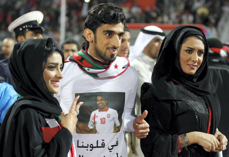 UAE's Hamdan Ismail Al Obaidly poses with fans after winning their game against Iraq at the Gulf Cup Tournament in Isa Town, January 18, 2013. REUTERS/Mohammed Dabbous (BAHRAIN - Tags: SPORT SOCCER) *** Local Caption ***  BAH25D_SOCCER-_0118_11.JPG