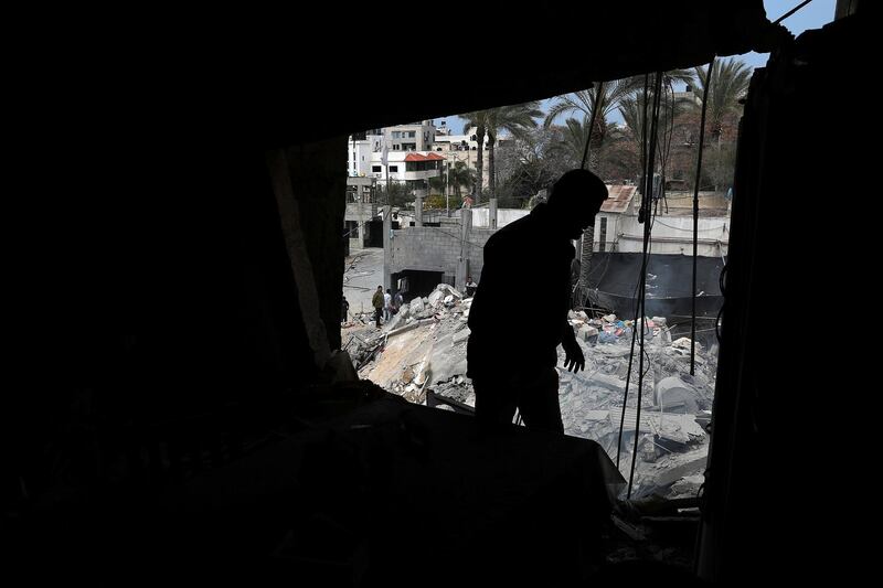A Palestinian man inspects his damaged house after Israeli air strikes. Reuters