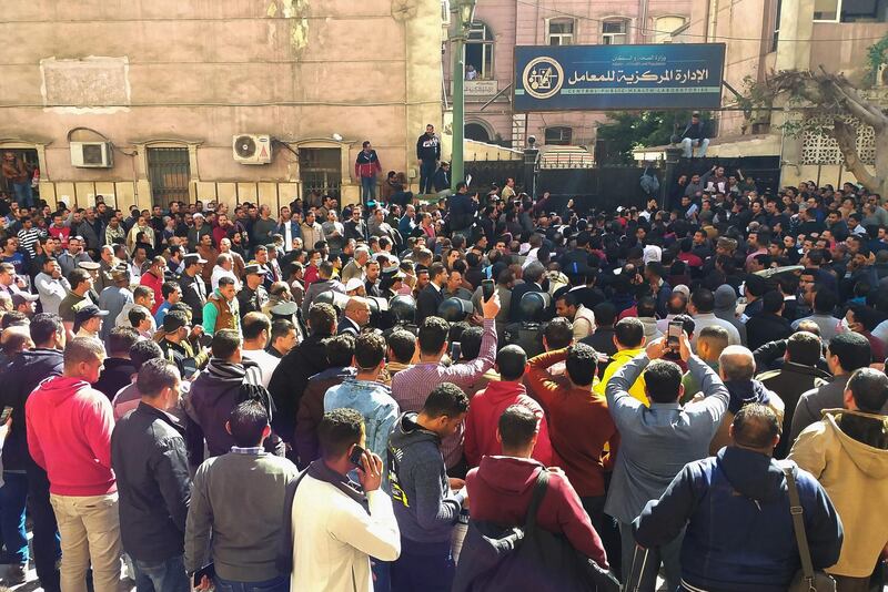 Egyptians bound for GCC countries gather in front of the Central Public Health Laboratories in downtown Cairo as they wait to get tested for coronavirus. AFP