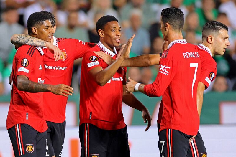 French striker Anthony Martial is congratulated by teammates after scoring the second. AFP