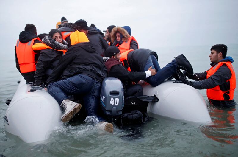 Migrants clamber aboard a flimsy inflatable dinghy as they prepare to leave Wimereux, near Calais, north France, heading for England. Reuters