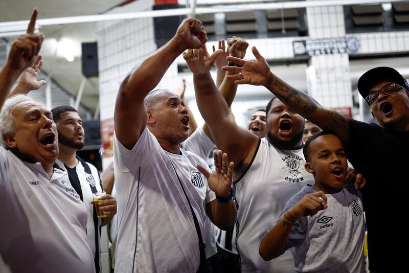 Fans of Pele gather to mourn his death in Santos. Reuters