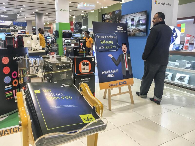 DUBAI, UNITED ARAB EMIRATES. 21 DECEMBER 2017. Shopping in Dubai Mall before the implementation of VAT across the UAE. VAT Signage at SharafDG stores. (Photo: Antonie Robertson/The National) Journalist: None. Section: National.