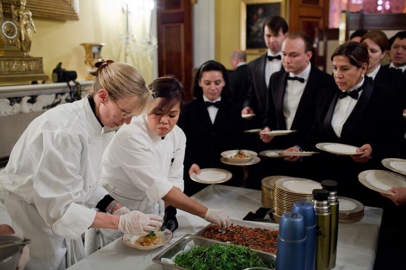 Ms Comerford, second left, works with staff in the Old Family Dining Room of the White House to plate a course in 2011. Photo: Official White House Photo / Pete Souza