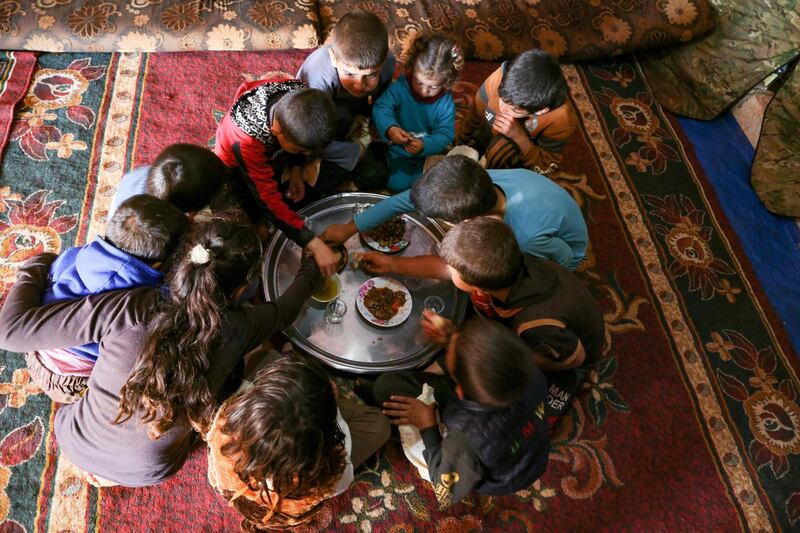 Some of Abderrazaq Khatoun's grandchildren share a meal. AFP