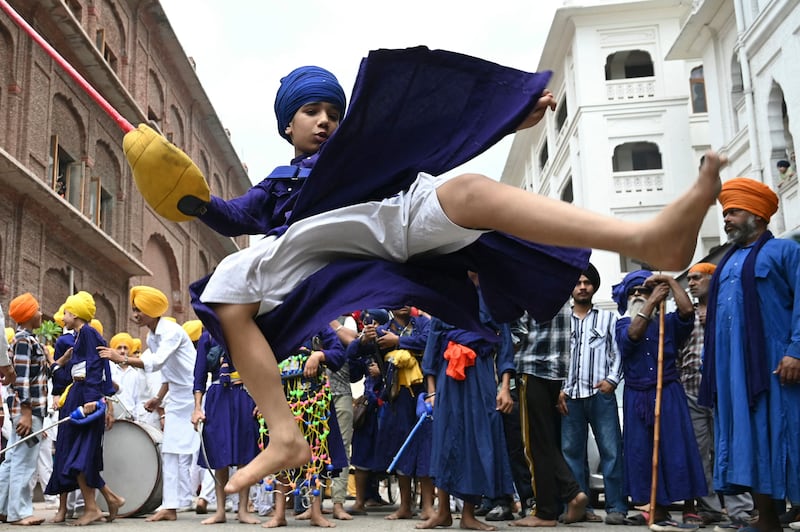 A Sikh youth performs Gatka, an ancient martial art, during a religious procession to mark the birth anniversary of the ninth Sikh Guru Teg Bahadur at the Golden Temple in Amritsar, Punjab, India, on Saturday, April 27.  AFP
