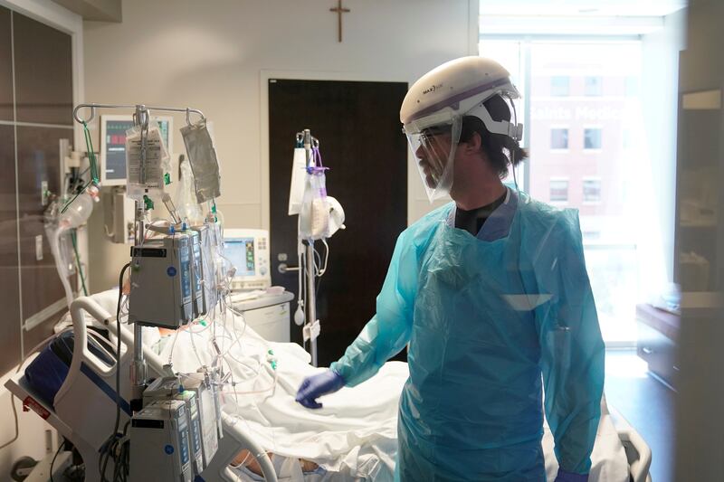 A nurse works in a Covid-19 patient's room during a tour of SSM Health St.  Anthony Hospital's intensive care unit in Oklahoma City. Reuters