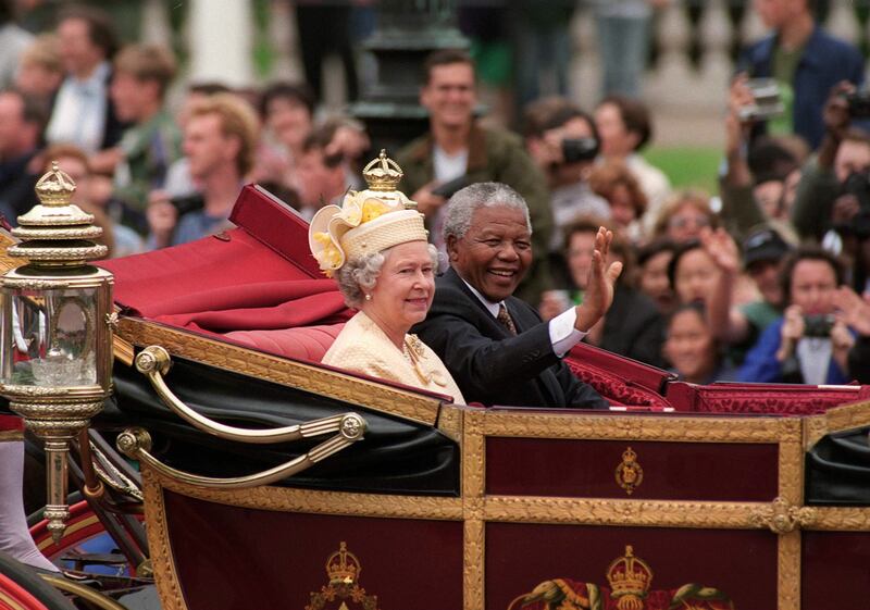 Queen Elizabeth with the late president Nelson Mandela of South Africa riding in a carriage on The Mall in London, in July 1996. Getty Images