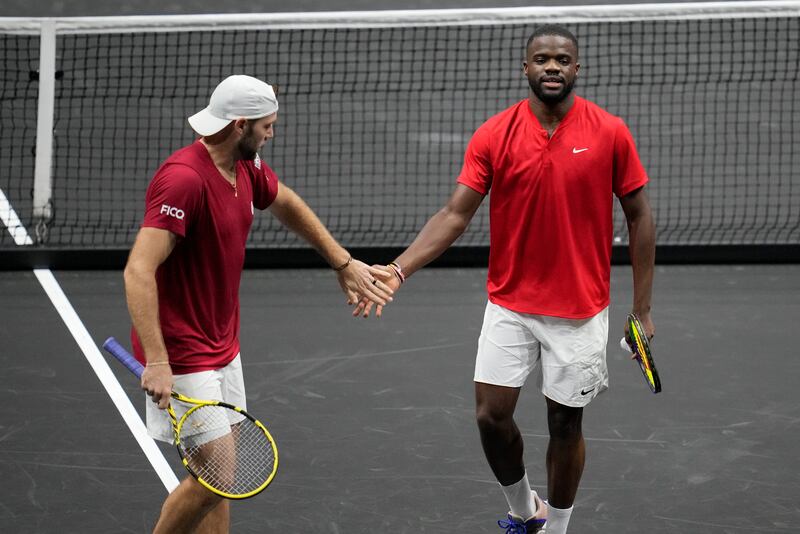 Team World's Jack Sock, left, and Frances Tiafoe react after winning a point against Team Europe's Roger Federer and Rafael Nadal. AP