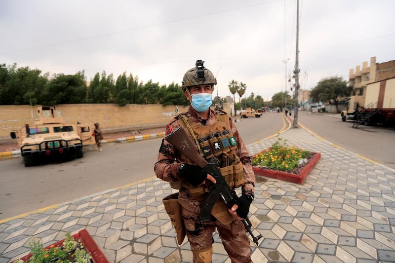 A soldier wears a protective face mask as he stands guard on a street during a curfew imposed to prevent the spread of coronavirus disease (COVID-19) in Baghdad, Iraq. Reuters