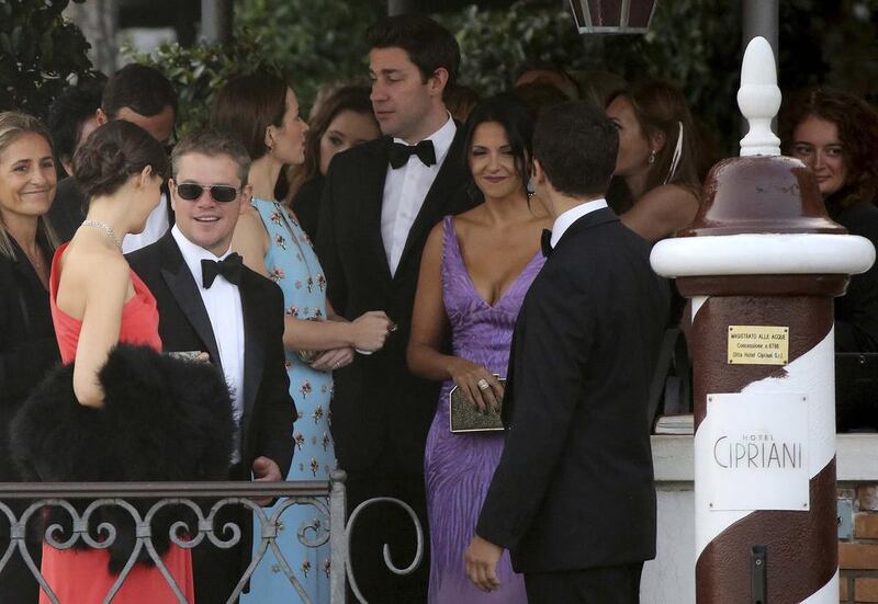 Actor Matt Damon (second left) and his wife Luciana Barroso (second right) arrive to board a taxi boat transporting guests to the venue of a gala dinner in Venice. Reuters