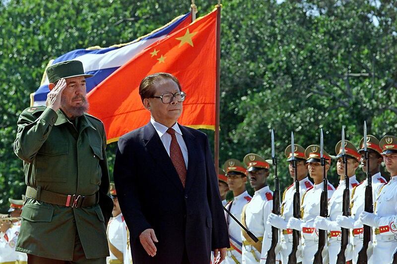 Fidel Castro reviews a guard of honour with visiting Chinese president Jiang Zemin in Havana on April 12, 2001. Adalberto Roque / AFP