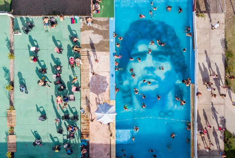 The face of Diego Maradona peers up from the bottom of a pool in a tribute to the late Argentine footballer near Buenos Aires. AFP