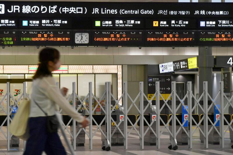 A person walks past closed ticket gates at a train station in Hiroshima, western Japan. AP
