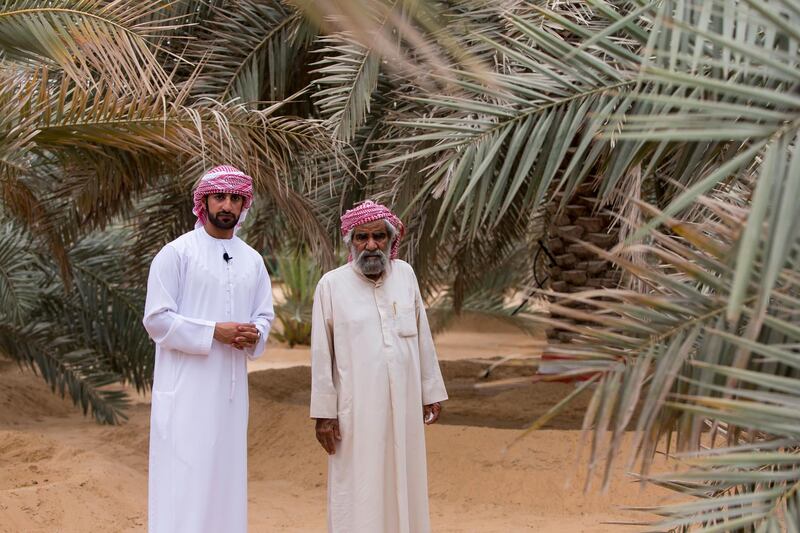 Liwa, United Arab Emirates, July 20, 2017:    Rashed Abdullah, centre, winner of the largest date branch for the Liwa Date Festival with his uncle  Ali Al Mehri, at his farm in the Al Dhafra Region of Abu Dhabi on July 20, 2017. The festival runs from July 19th to 29th. Christopher Pike / The National

Reporter: Anna Zacharias
Section: News