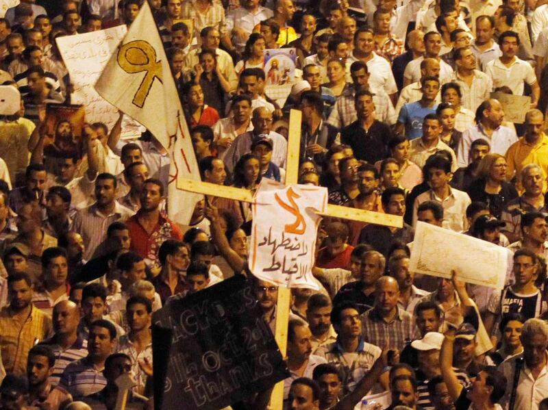 Egyptian Christians march in Cairo during a protest against an attack on a church in southern Egypt , October 9, 2011. Nineteen people were killed in Cairo on Sunday when Christians, some carrying crosses and pictures of Jesus, clashed with military police, medical and security sources said, in the latest sectarian flare-up in a country in political turmoil. REUTERS/Mohamed Abd El-Ghany  (EGYPT - Tags: CIVIL UNREST POLITICS RELIGION) *** Local Caption ***  AMR27_EGYPT-COPTS-C_1009_11.JPG