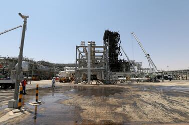 Workers are seen at the damaged site of Saudi Aramco oil facility in Khurais. Reuters