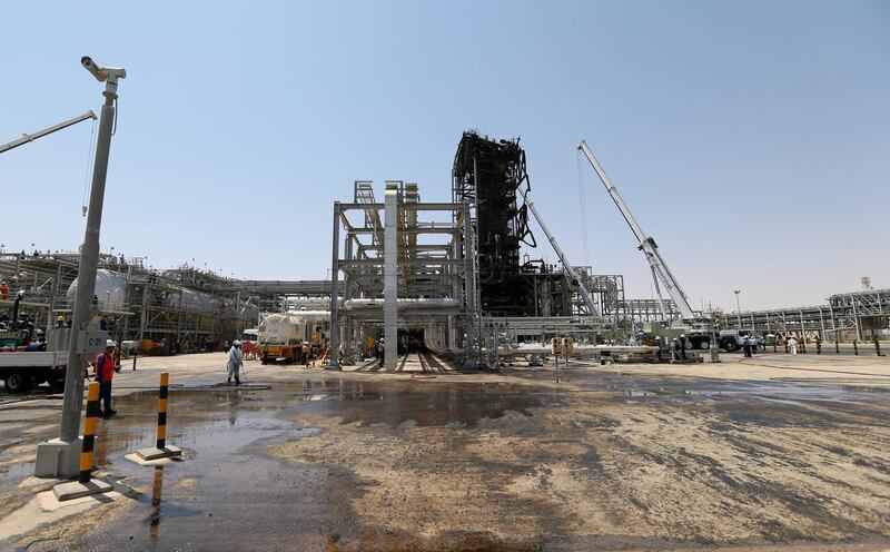 FILE PHOTO: Workers are seen at the damaged site of Saudi Aramco oil facility in Khurais, Saudi Arabia, September 20, 2019. REUTERS/Hamad l Mohammed//File Photo