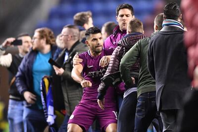 WIGAN, ENGLAND - FEBRUARY 19:  Sergio Aguero of Manchester City is surrounded by fans as he attempts to leave the pitch after the Emirates FA Cup Fifth Round match between Wigan Athletic and Manchester City at DW Stadium on February 19, 2018 in Wigan, England.  (Photo by Gareth Copley/Getty Images)