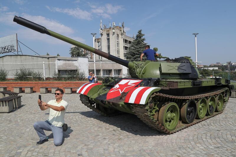 A Red Star Belgrade fan takes a selfie in front of the Soviet-made T-55 main battle tank in front of Rajko Mitic stadium. Reuters