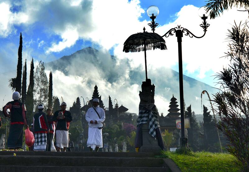 Balinese people pray for Mount Agung during Purnama ceremony on Bali island.  Sonny Tumbelaka / AFP Photo