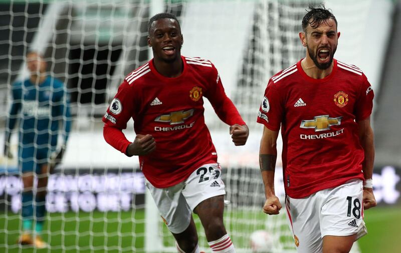 Fernandes (R) celebrates scoring their second goal. AFP