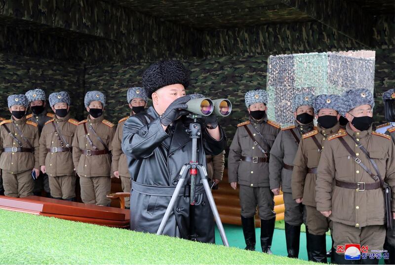 North Korean leader Kim Jong-un, centre, inspects the military drill of units of the Korean People's Army, with soldiers shown wearing face masks.  AP
